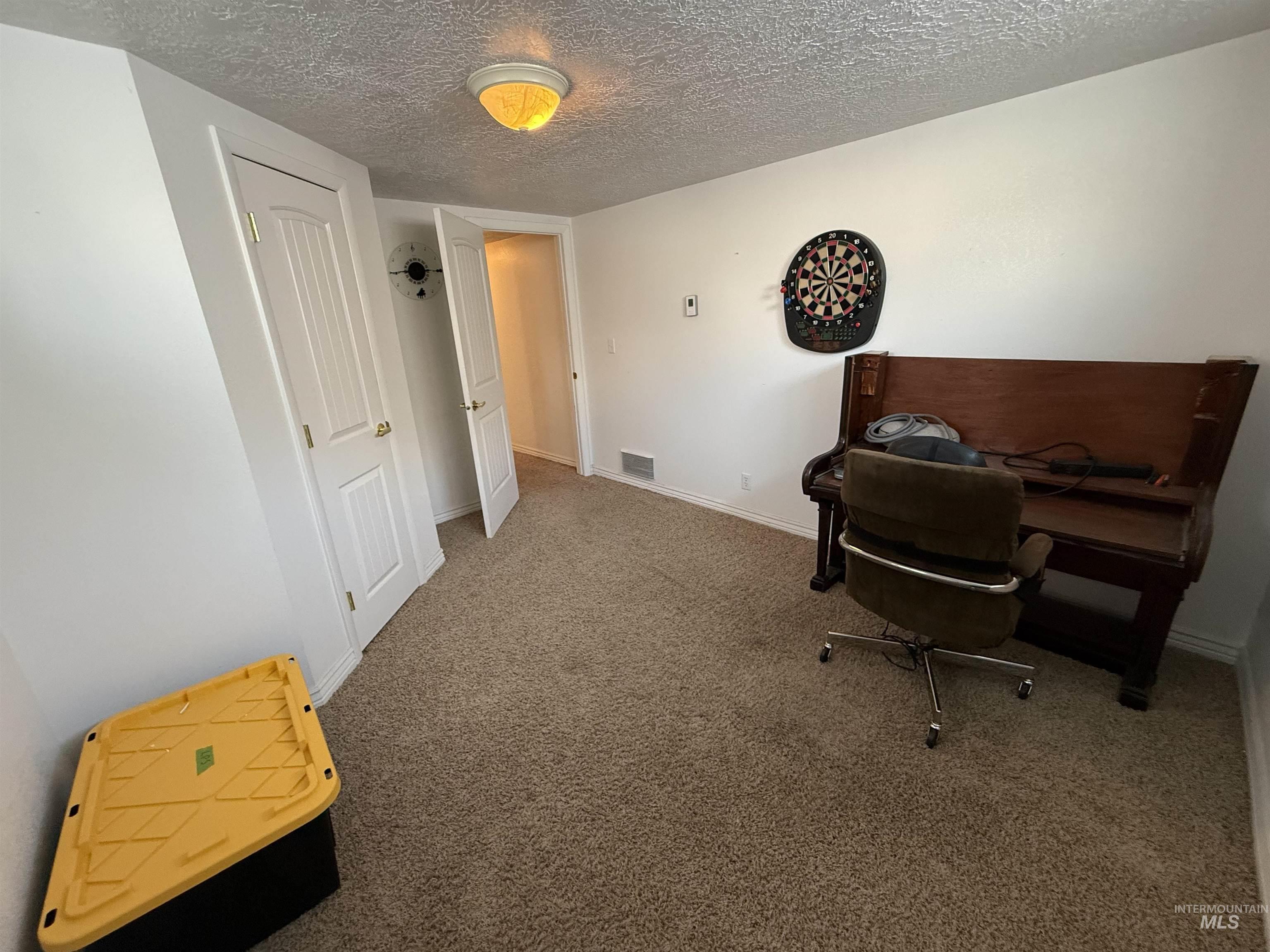 4926 Easy Street Chubbuck, ID 83202 - Photo 11 of 29 Office space featuring carpet flooring and a textured ceiling