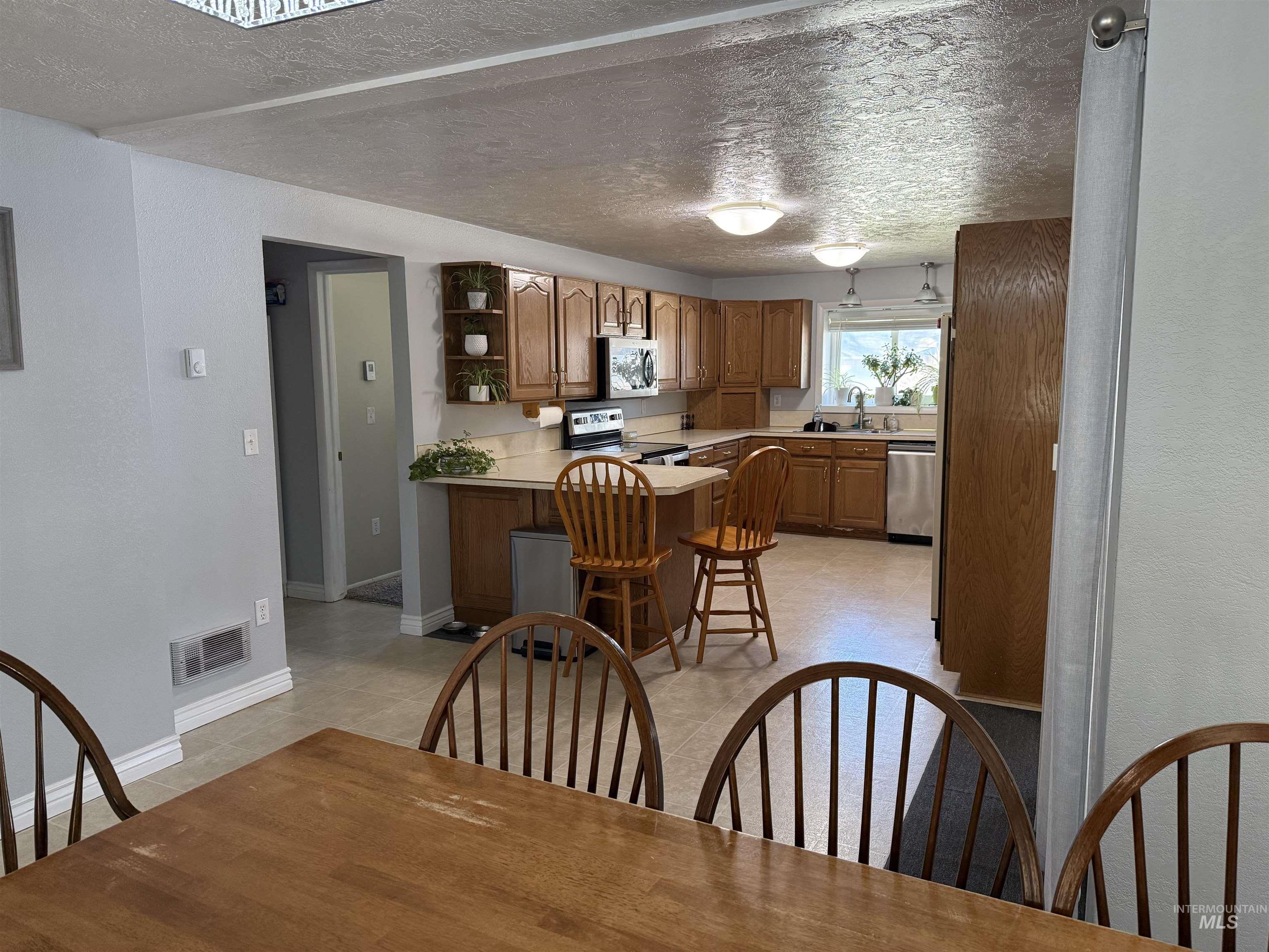 4926 Easy Street Chubbuck, ID 83202 - Photo 8 of 29 Dining space featuring a textured ceiling