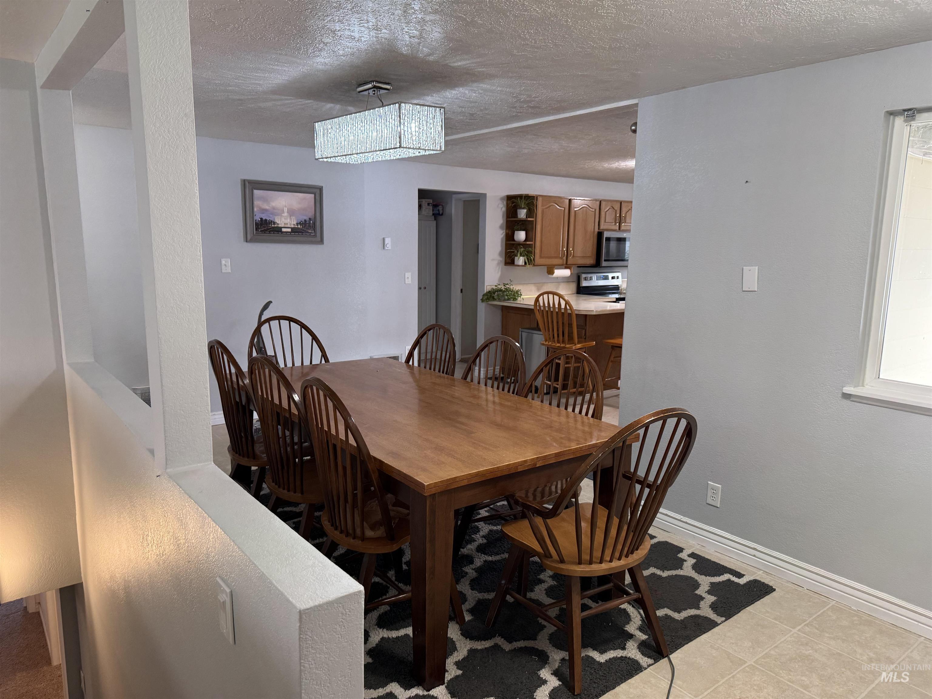 4926 Easy Street Chubbuck, ID 83202 - Photo 9 of 29 Dining area featuring a textured ceiling