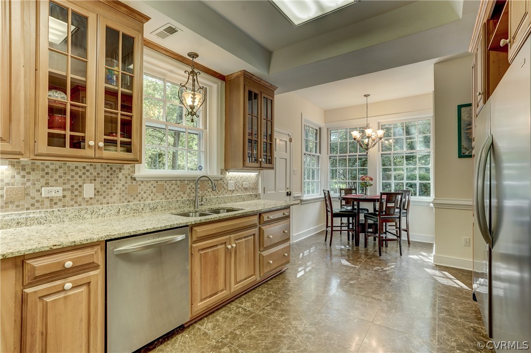 4701 Butte Road Richmond, VA 23235 - Photo 12 of 47 a kitchen with refrigerator cabinets and dining table
