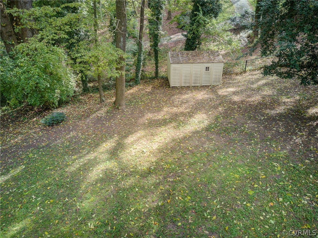4701 Butte Road Richmond, VA 23235 - Photo 14 of 47 a backyard of a house with large trees and plants