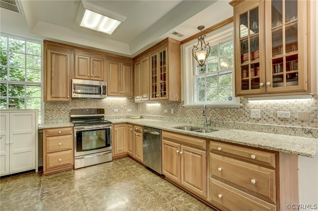 4701 Butte Road Richmond, VA 23235 - Photo 18 of 47 a kitchen with granite countertop a stove a sink and a refrigerator
