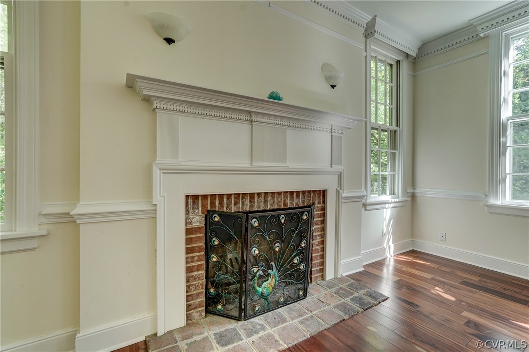 4701 Butte Road Richmond, VA 23235 - Photo 23 of 47 an empty room with wooden floor a fireplace and windows