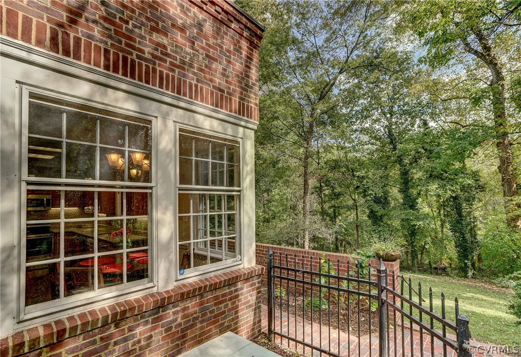 4701 Butte Road Richmond, VA 23235 - Photo 37 of 47 a view of a house with a large window and wooden fence