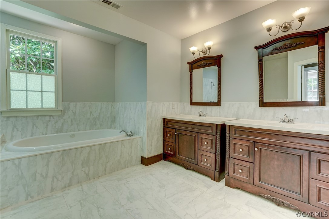 4701 Butte Road Richmond, VA 23235 - Photo 8 of 47 a bathroom with a tub sink and mirror