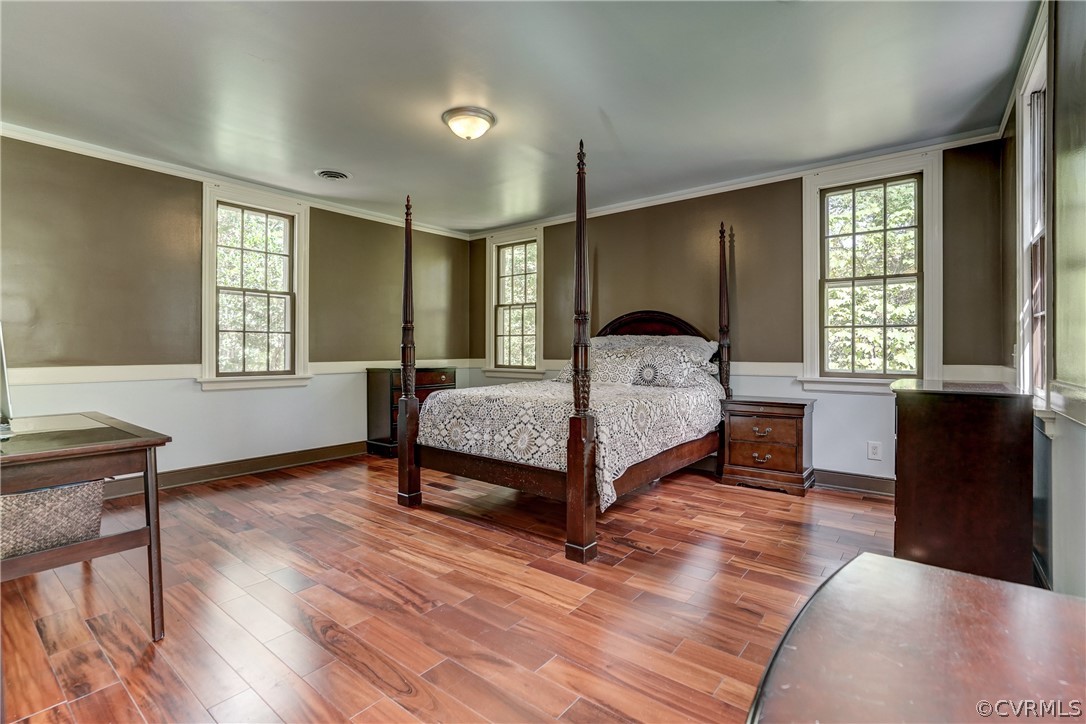 4701 Butte Road Richmond, VA 23235 - Photo 9 of 47 a bedroom with a bed table chair and a window