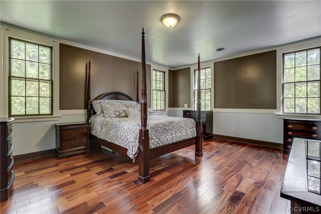 4701 Butte Road Richmond, VA 23235 - Photo 10 of 47 a bedroom with a bed window and wooden floor