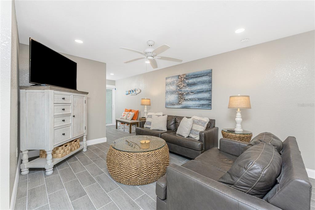 5041 North Beach Road, Unit 3A AND 3B Englewood, FL 34223 - Photo 12 of 52 a living room with furniture and a flat screen tv