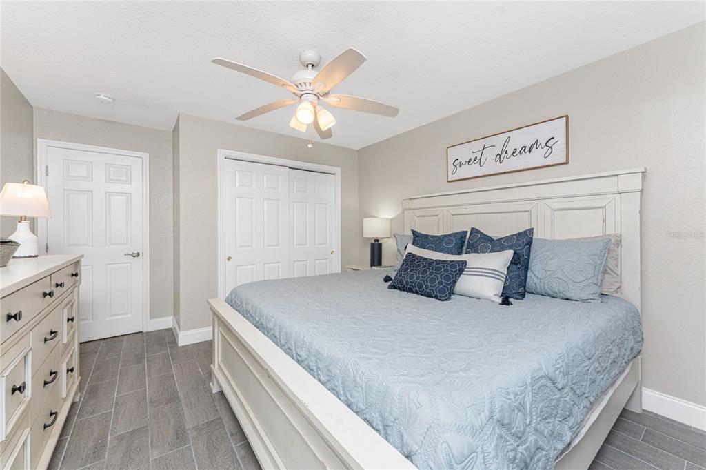5041 North Beach Road, Unit 3A AND 3B Englewood, FL 34223 - Photo 17 of 52 a spacious bedroom with a bed and cabinet