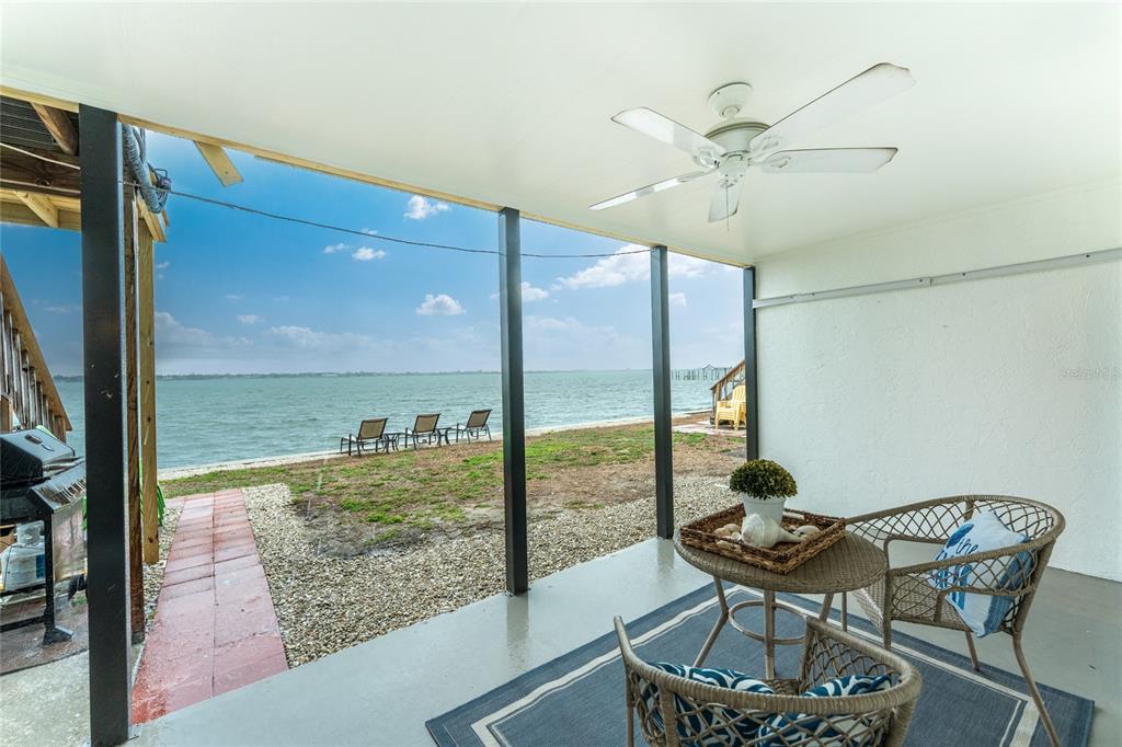 5041 North Beach Road, Unit 3A AND 3B Englewood, FL 34223 - Photo 23 of 52 a view of a room with a table and chairs
