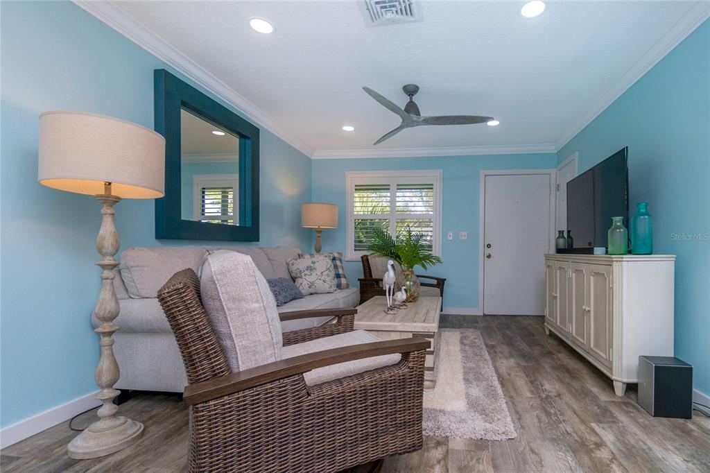 5041 North Beach Road, Unit 3A AND 3B Englewood, FL 34223 - Photo 30 of 52 a living room with furniture and a flat screen tv