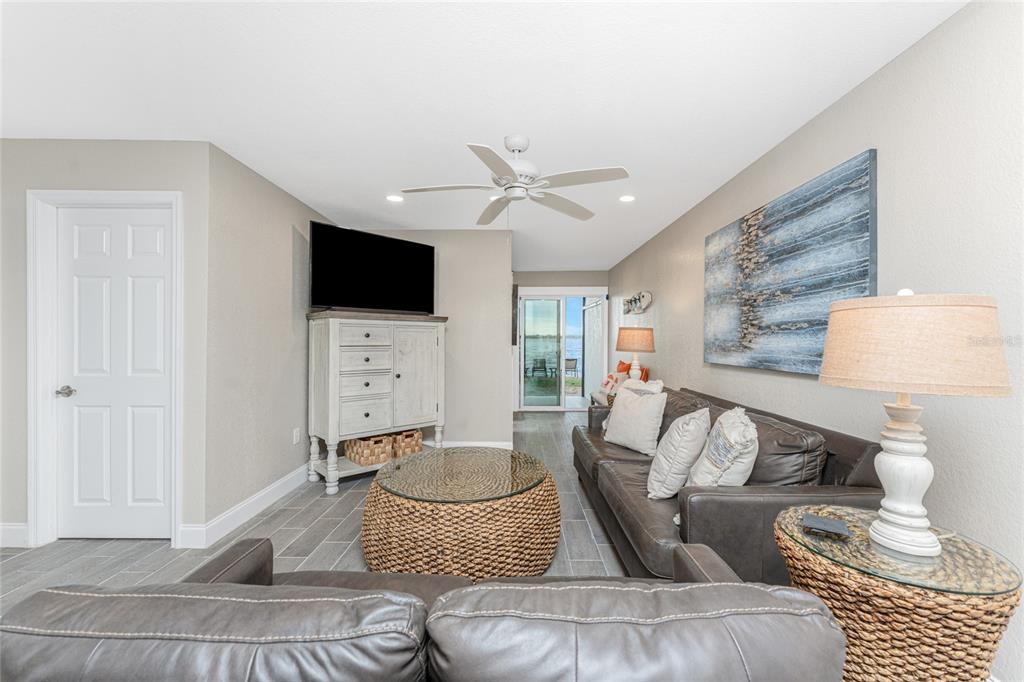 5041 North Beach Road, Unit 3A AND 3B Englewood, FL 34223 - Photo 3 of 52 a living room with furniture and a flat screen tv