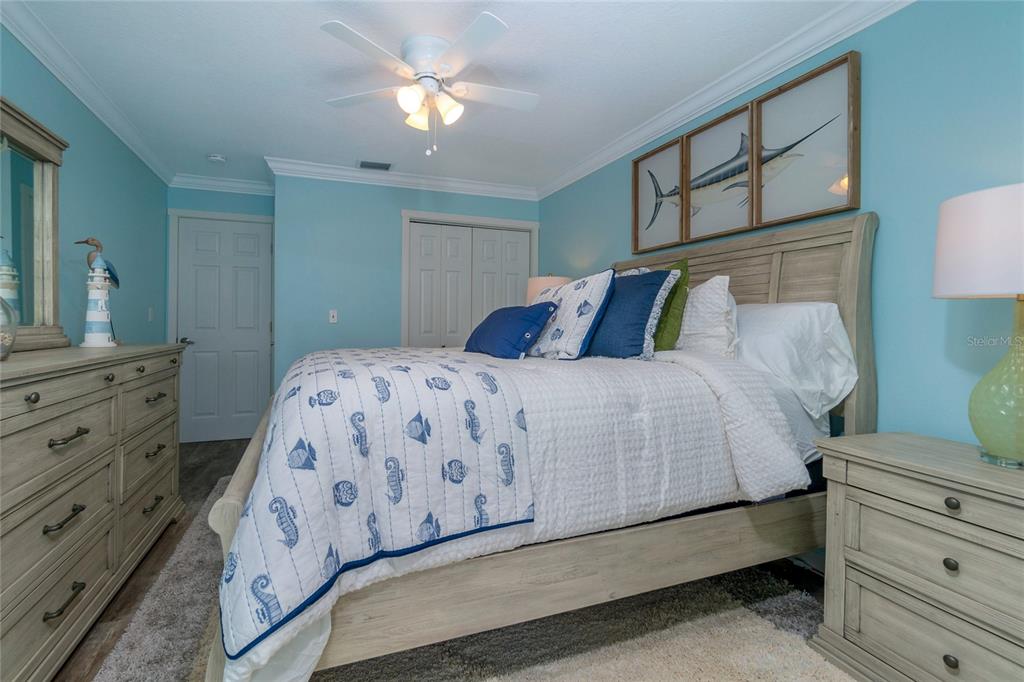 5041 North Beach Road, Unit 3A AND 3B Englewood, FL 34223 - Photo 44 of 52 a bedroom with a bed and a dresser