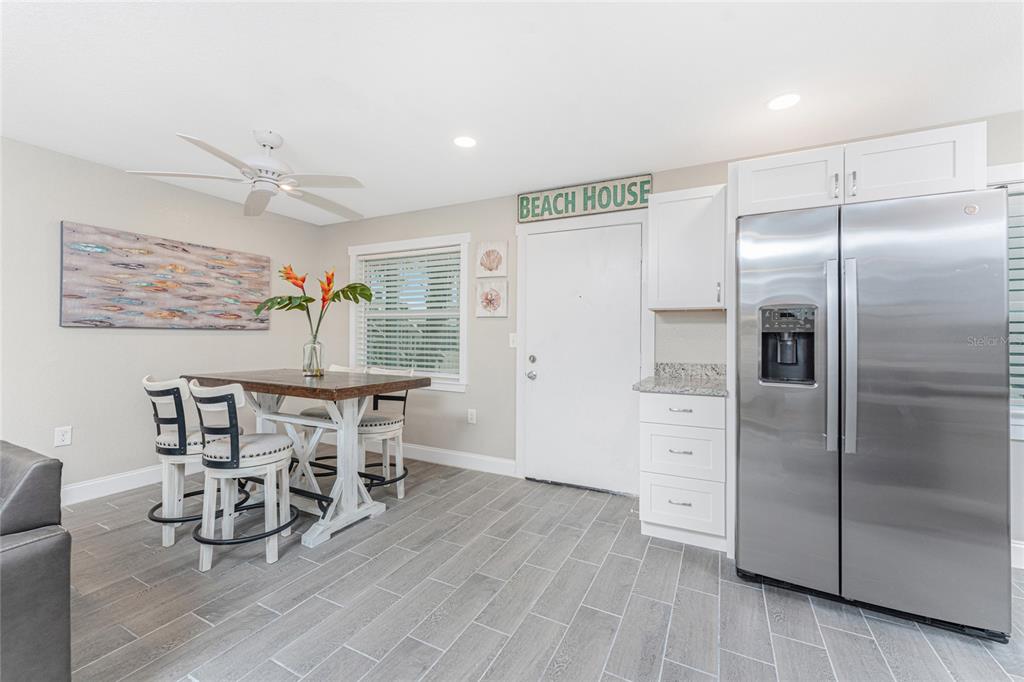 5041 North Beach Road, Unit 3A AND 3B Englewood, FL 34223 - Photo 8 of 52 a kitchen with stainless steel appliances a refrigerator and a dining table