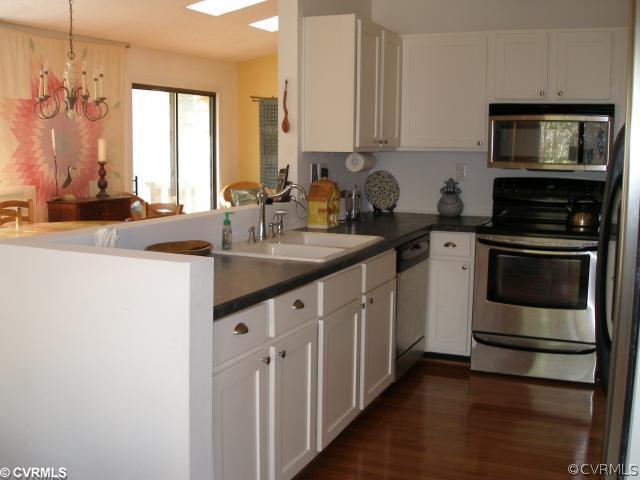 3205 Shadow Oaks Road Midlothian, VA 23112 - Photo 8 of 11 a kitchen with stainless steel appliances granite countertop a sink stove and microwave