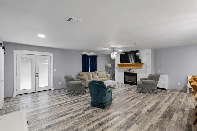 a living room with furniture a fireplace and a flat screen tv