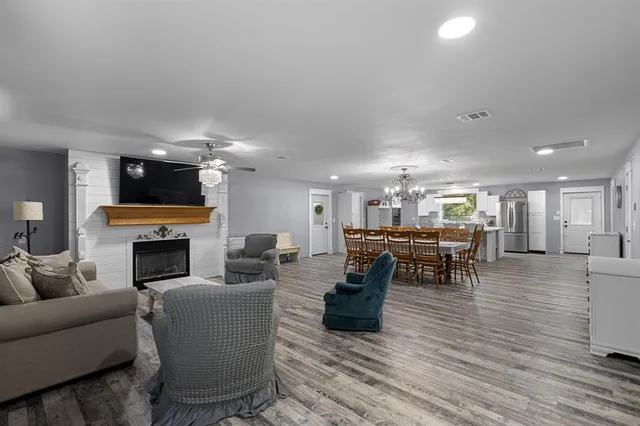 a living room with furniture a fireplace and a flat screen tv