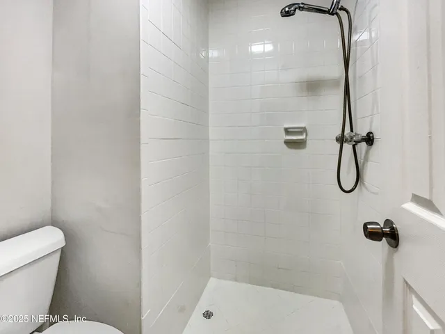 a bathroom with a shower and a toilet