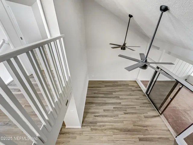 a view of staircase with white walls and a window