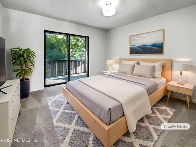 a bedroom with a bed and a large window