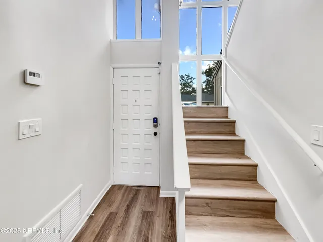 a view of an entryway with wooden floor