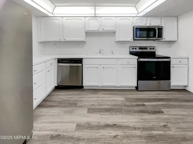 a kitchen with stainless steel appliances granite countertop a stove and a sink