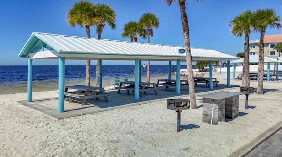 7 Elisabethan Lane New Port Richey, FL 34652 - Photo 15 of 16 a view of a patio with a table and chairs under an umbrella