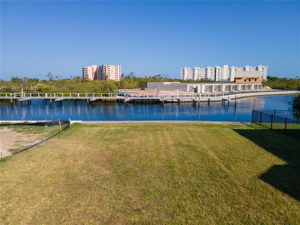 7 Elisabethan Lane New Port Richey, FL 34652 - Photo 2 of 16 a view of a swimming pool with an outdoor space and seating area