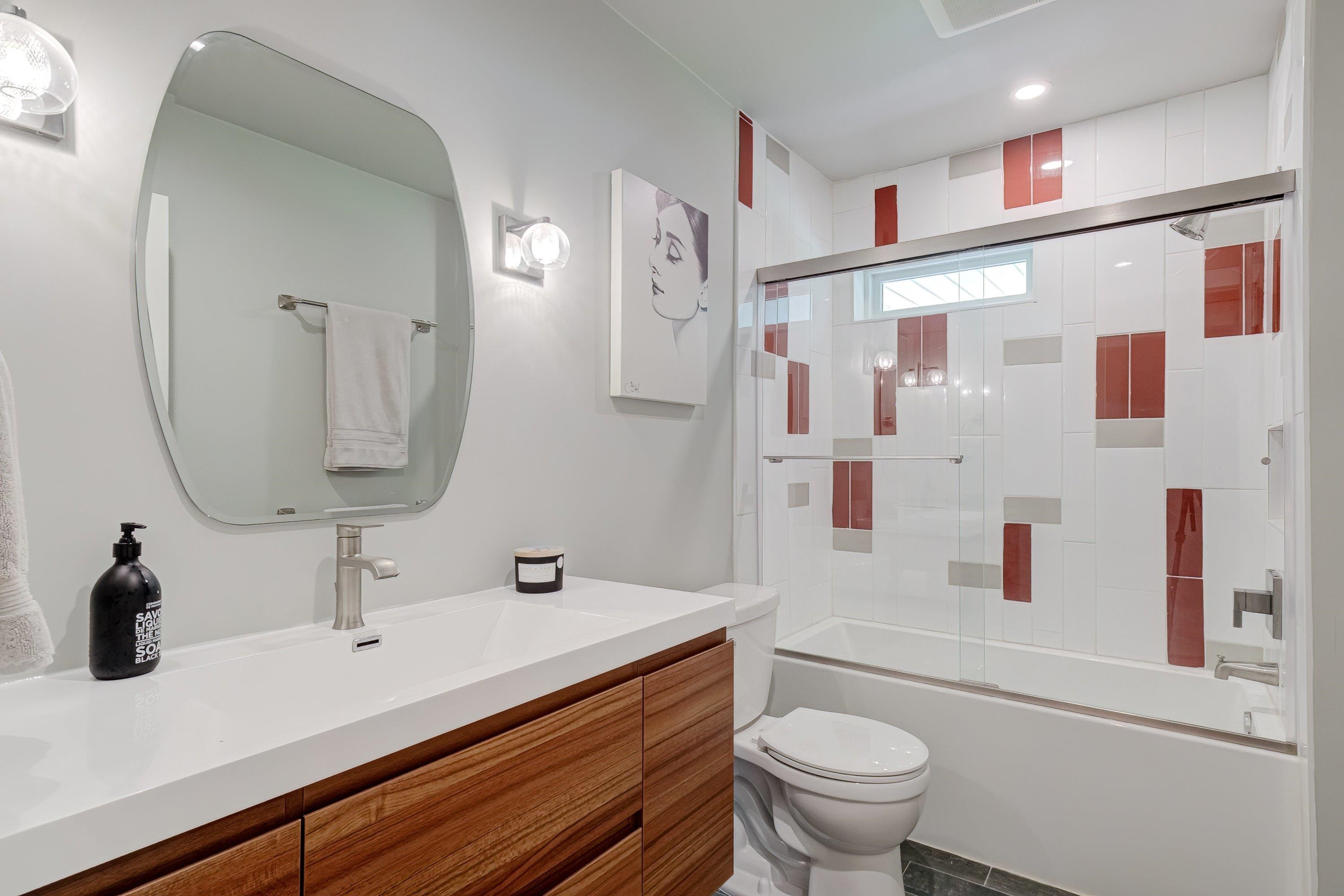 2405 Brenda Drive Raleigh, NC 27610 - Photo 19 of 27 a bathroom with a sink a toilet a mirror and shower