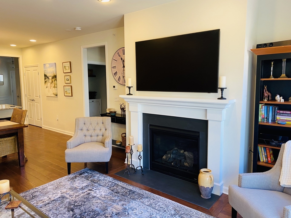 41 Shannon Way, Unit 41 Upton, MA 01568 - Photo 16 of 36 a living room with furniture a flat screen tv and a fireplace