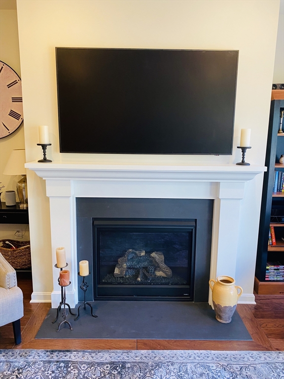 41 Shannon Way, Unit 41 Upton, MA 01568 - Photo 17 of 36 a living room with a fireplace and a flat screen tv