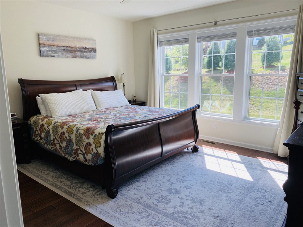 41 Shannon Way, Unit 41 Upton, MA 01568 - Photo 19 of 36 a large bed sitting in a bedroom next to a window