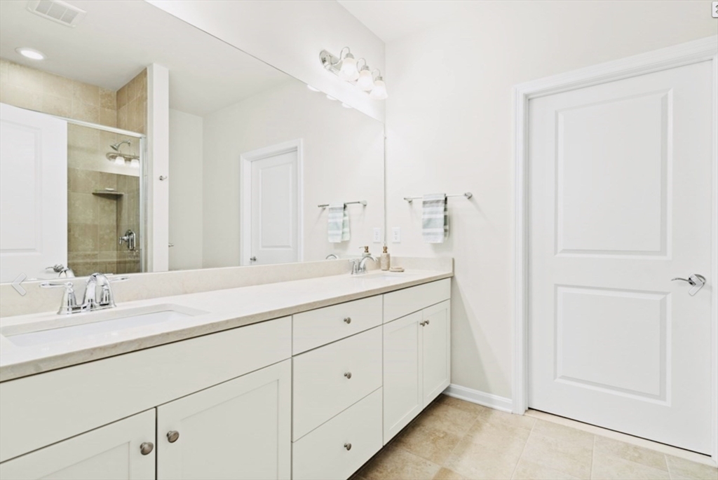 41 Shannon Way, Unit 41 Upton, MA 01568 - Photo 21 of 36 a bathroom with a double vanity sink and mirror