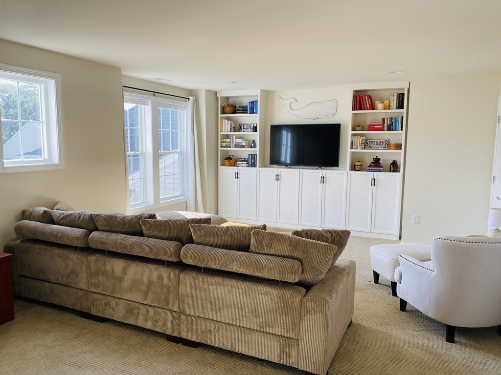 41 Shannon Way, Unit 41 Upton, MA 01568 - Photo 22 of 36 a living room with furniture and a flat screen tv