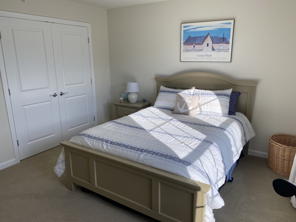 41 Shannon Way, Unit 41 Upton, MA 01568 - Photo 25 of 36 a bedroom with a bed and a painting on the wall