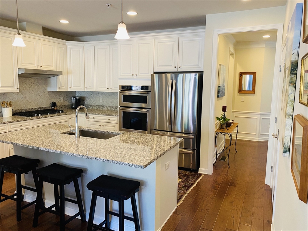 41 Shannon Way, Unit 41 Upton, MA 01568 - Photo 9 of 36 a kitchen with stainless steel appliances granite countertop a sink refrigerator and cabinets