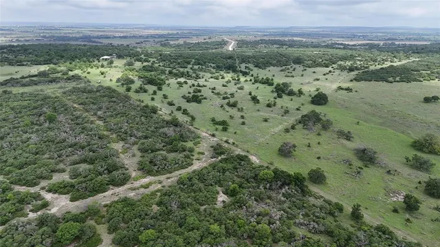 an aerial view of a houses with a yard