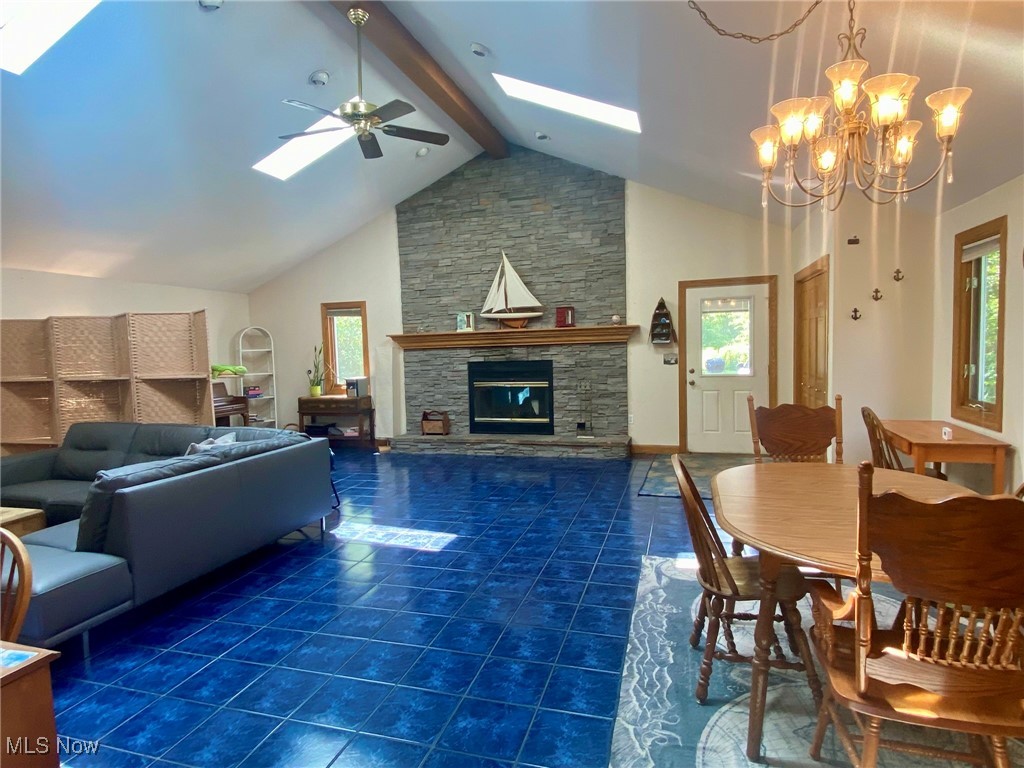 1568 Sunview Road Cleveland, OH 44124 - Photo 2 of 50 Tiled living room with a skylight, a ceiling fan, a fireplace, plenty of natural light, and beam ceiling