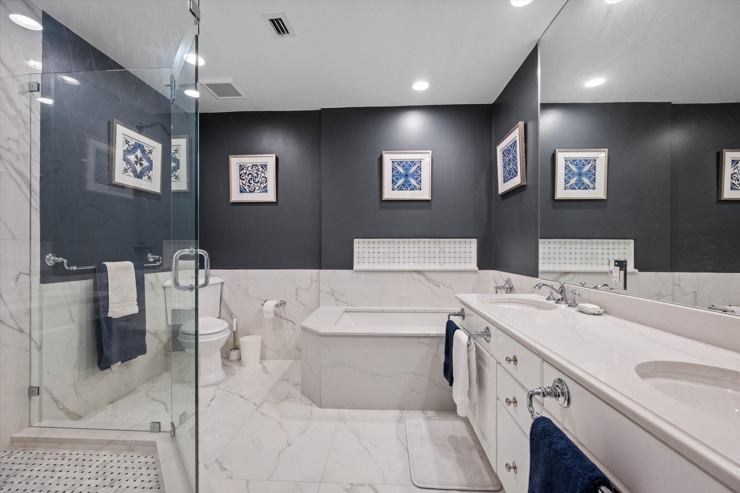 13254 Polo Club Road, Unit C202 Wellington, FL 33414 - Photo 16 of 27 a view of a bathroom with a sink a mirror and a bathtub