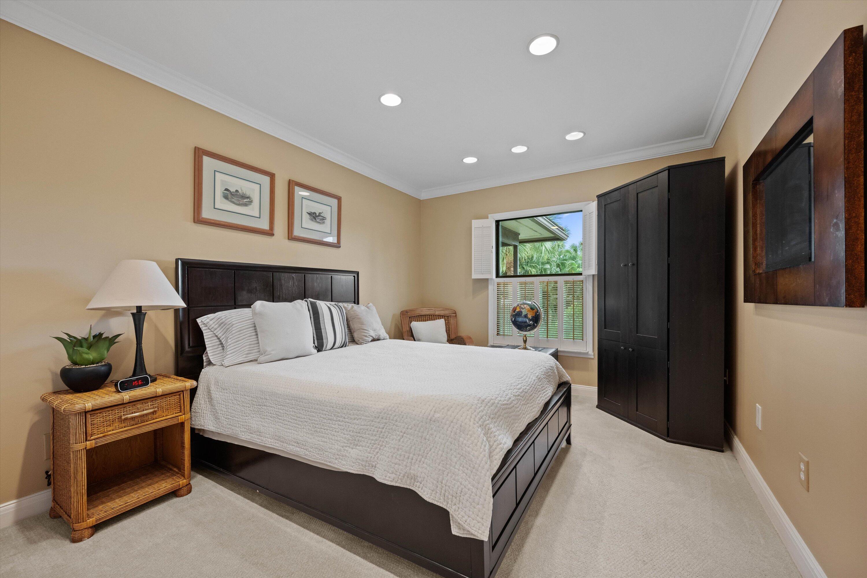 13254 Polo Club Road, Unit C202 Wellington, FL 33414 - Photo 18 of 27 a bedroom with a bed and a night stand