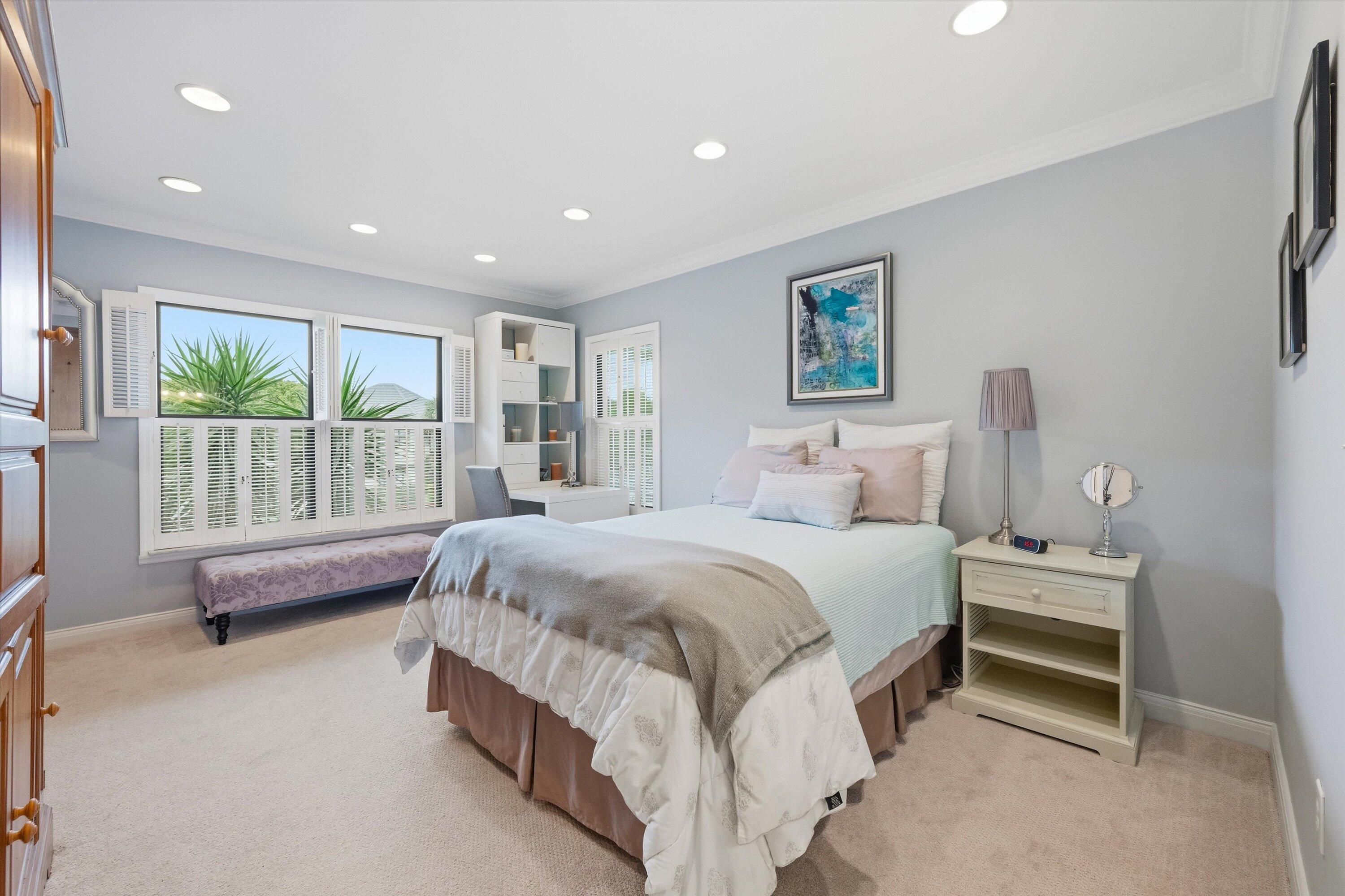 13254 Polo Club Road, Unit C202 Wellington, FL 33414 - Photo 20 of 27 a spacious bedroom with a bed and a couch