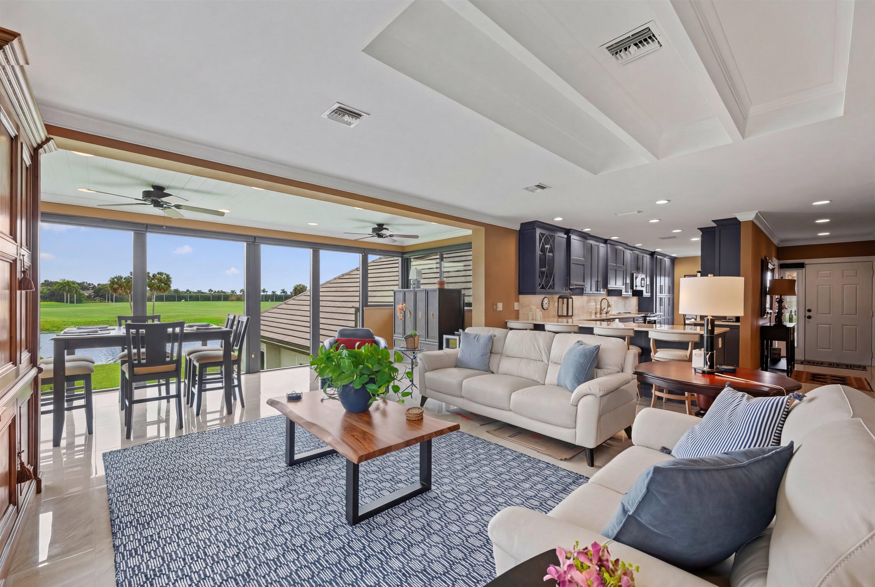 13254 Polo Club Road, Unit C202 Wellington, FL 33414 - Photo 2 of 27 a living room with furniture fireplace and floor to ceiling window