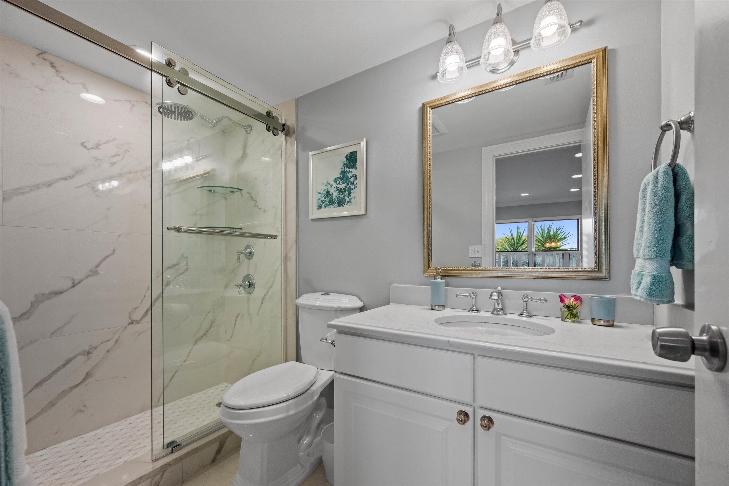 13254 Polo Club Road, Unit C202 Wellington, FL 33414 - Photo 21 of 27 a bathroom with a sink toilet and shower