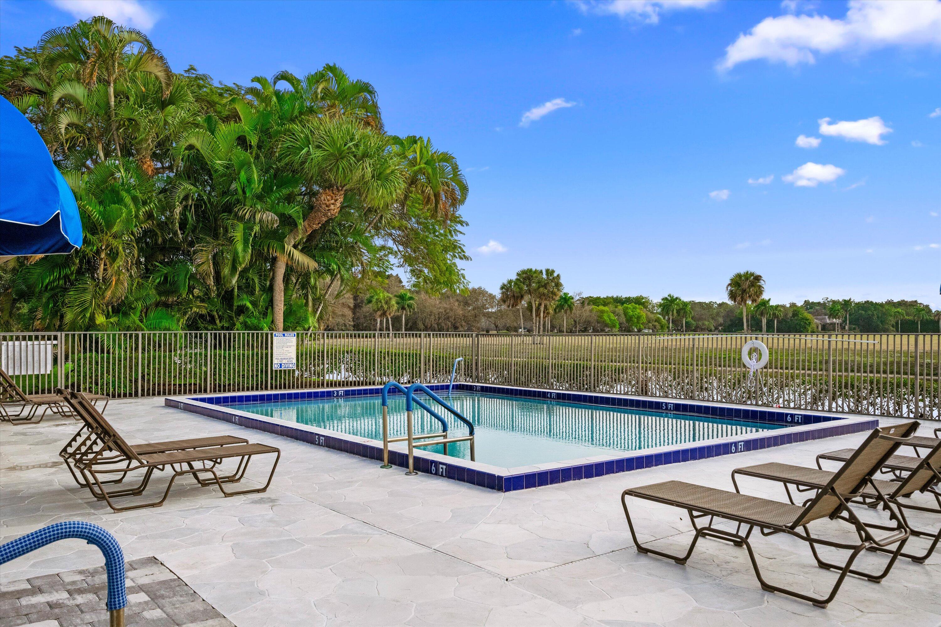 13254 Polo Club Road, Unit C202 Wellington, FL 33414 - Photo 27 of 27 a view of a chairs and table on the terrace