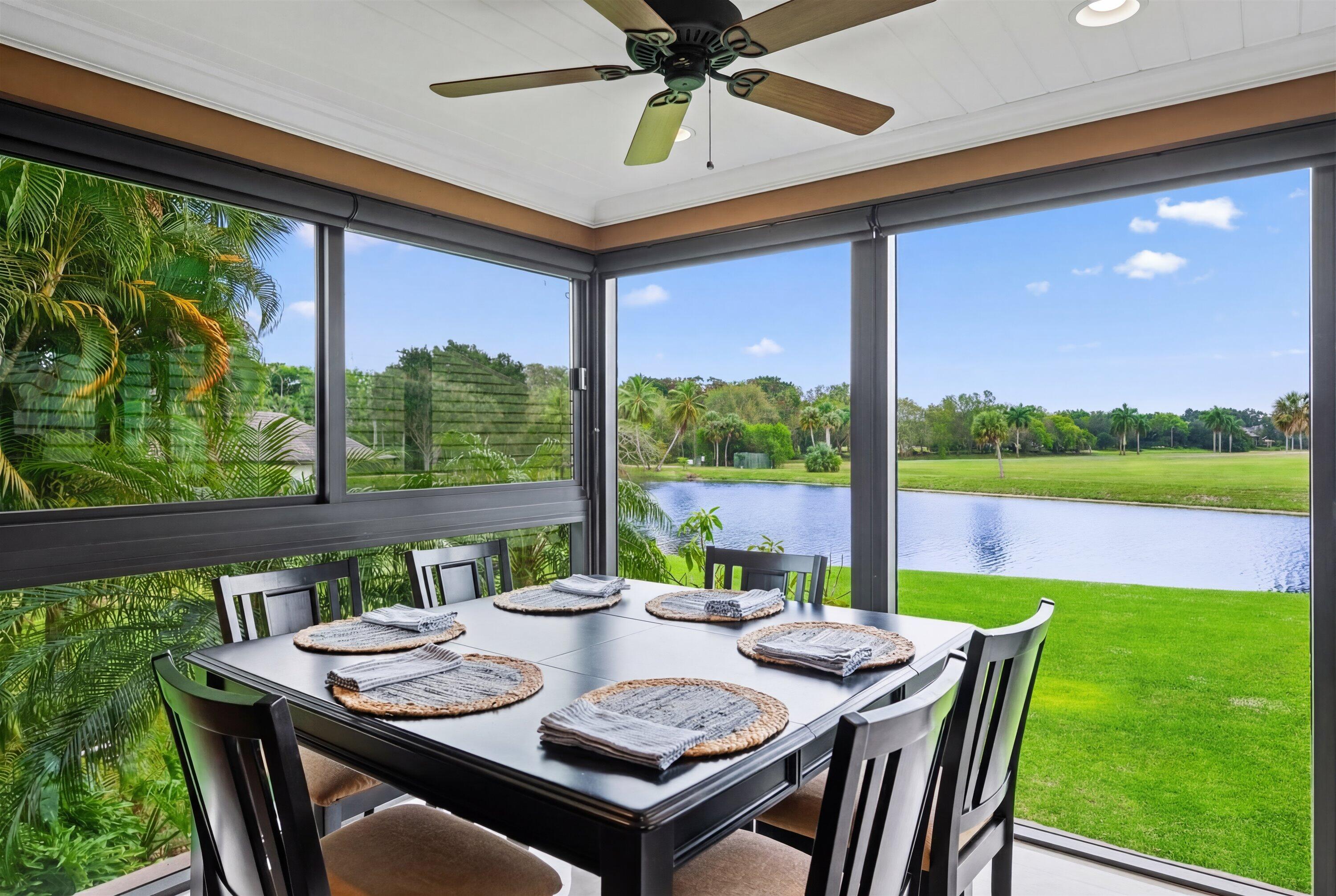 13254 Polo Club Road, Unit C202 Wellington, FL 33414 - Photo 9 of 27 a view of an outdoor dining space with a table and chairs