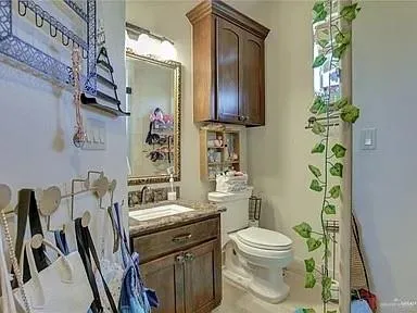 a bathroom with a toilet a sink and a mirror