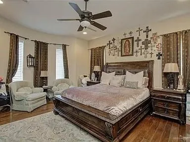 a bed sitting in a spacious bedroom next to a window