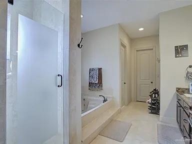 3429 South 3rd Street McAllen, TX 78503 - Photo 16 of 25 a bathroom with a bathtub and a shower