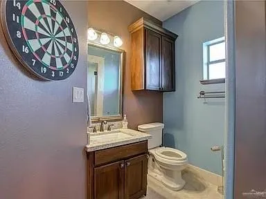 a bathroom with a toilet a sink and a mirror