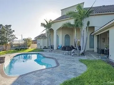 a view of a house with backyard porch and sitting area